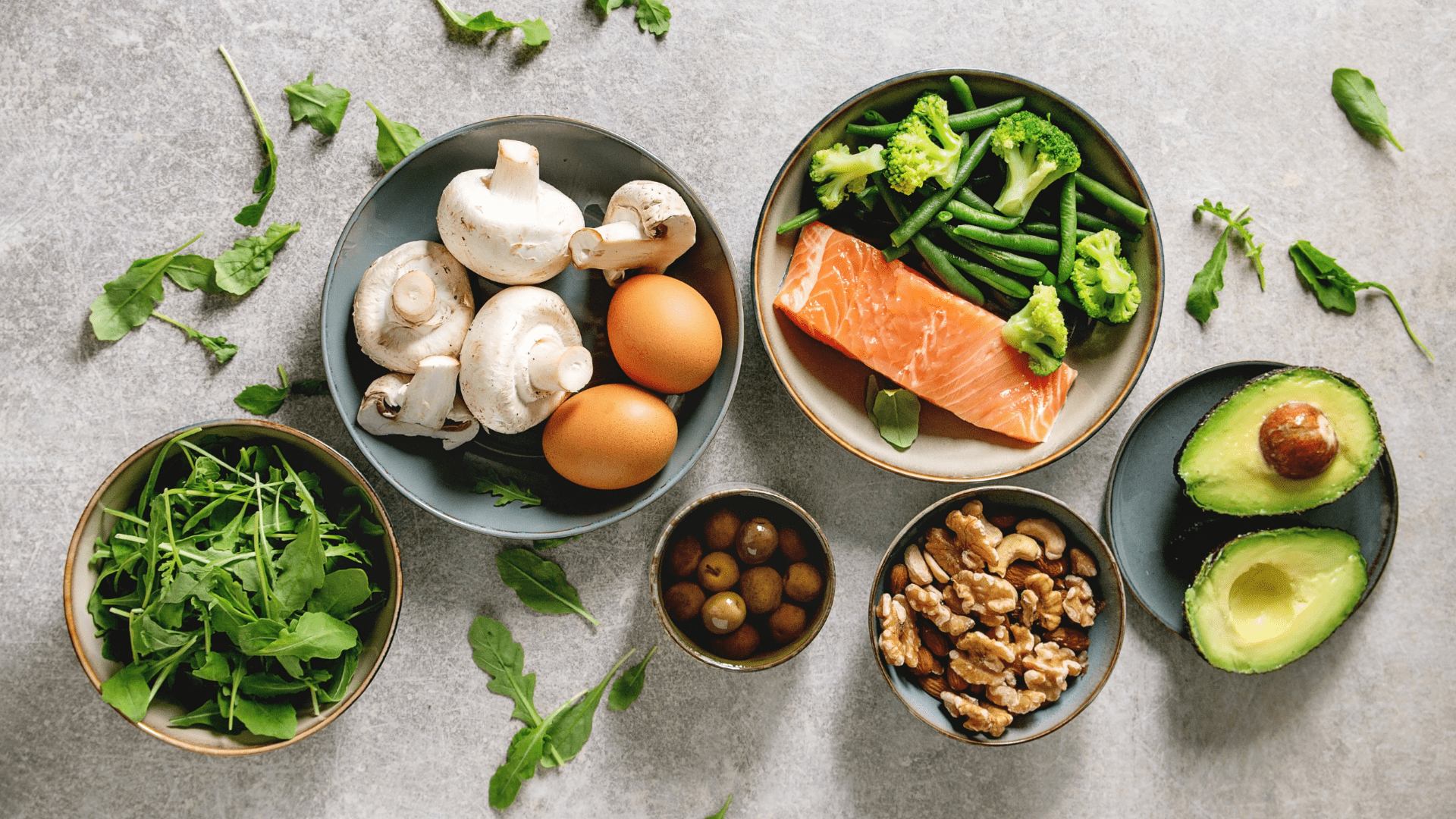 A table topped with bowls of food and vegetables.